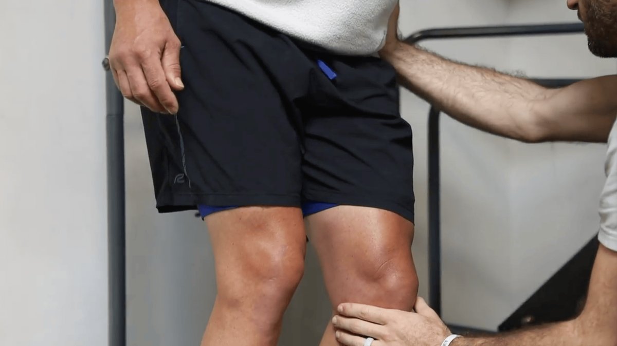Physical therapist checking an athlete's knee at One Nine Sports Medicine